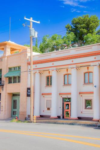 a large white building on the corner of a street at The Signature King with Mountain Views in Bisbee