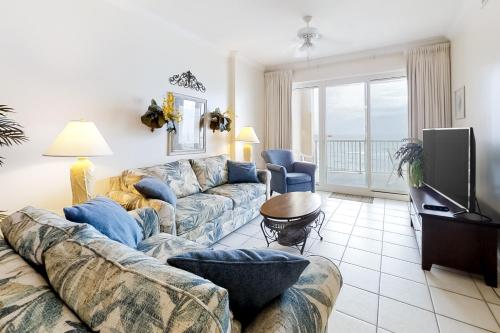 a living room with a couch and a tv at Island Royale 602 in Gulf Shores