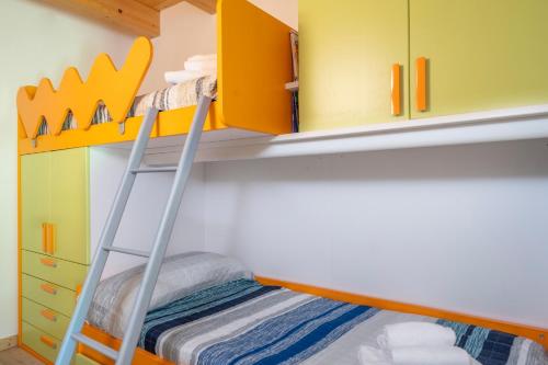 a bunk bed with a ladder in a childs bedroom at GuestHost - Sappada Lovely Lodge in Sappada