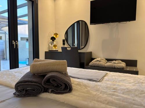 a bedroom with a bed with towels on it at Private Pool House By Natchos in Virós
