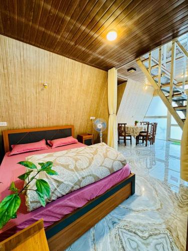 a bedroom with a bed and a dining room at The Tea Tribe Stay in Sonāda