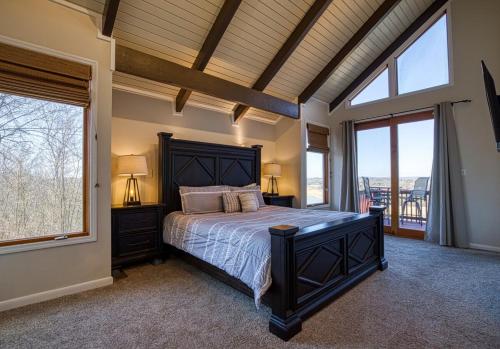 a bedroom with a large bed and a large window at Lake View Cabin Incredible Panoramic Views, Spa in Sevierville