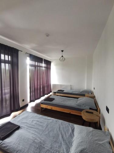 a bedroom with two beds and a window at Stalowy Gościniec in Stalowa Wola