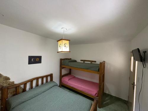 a bedroom with two bunk beds and a lamp at Jujuy Hostel in San Salvador de Jujuy