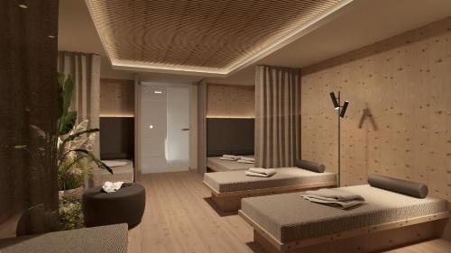 a hotel room with two beds in a room at Hotel Am Fels in Senales