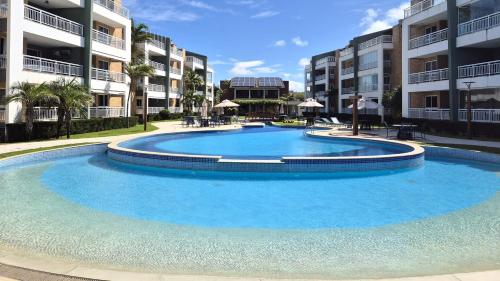 a large swimming pool in front of some apartment buildings at TerraMaris - Pé na Areia e Vista Mar Deslumbrante in Aquiraz