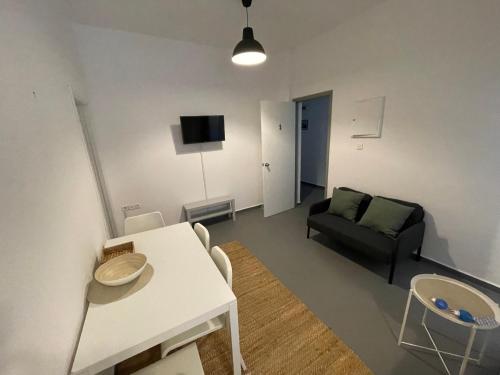 a living room with a couch and a table at Spanos Apartments - Panteli in Panteli