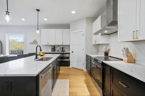 a kitchen with white cabinets and a black and white counter top at Valley View in Basye