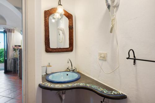 a bathroom with a sink and a mirror at Agriturismo Barone Antonio Negri in Fisciano