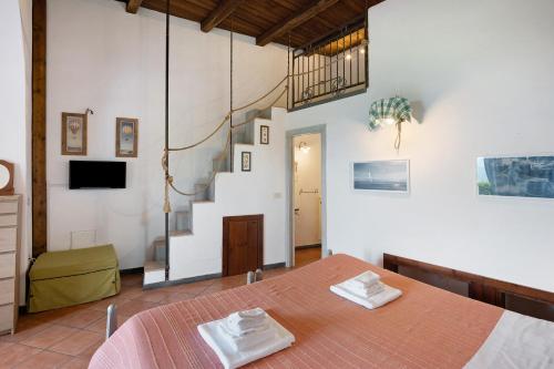 a room with a bed and a staircase at Agriturismo Barone Antonio Negri in Fisciano