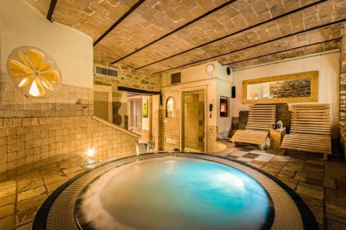 a large swimming pool in a room at I Capricci Di Merion - Resort & Spa in Tuoro sul Trasimeno