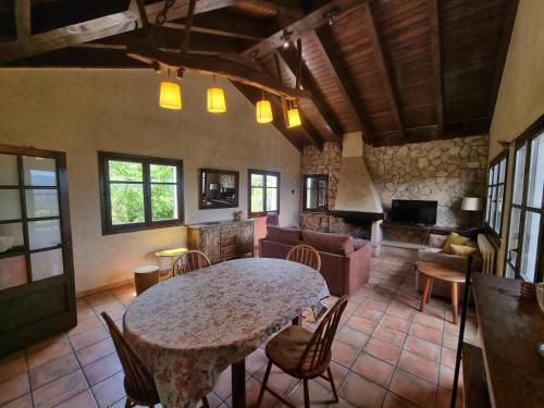 a living room with a table and a couch at L'AMAGATALL DEL MONTNEGRE in Villalba Saserra