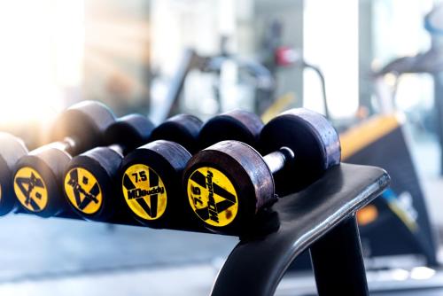 a row of dumbbells on a table in a gym at PC Residences Gulberg Lahore in Lahore