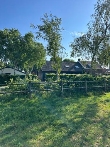 a wooden fence in front of a house at Heikant Hoeve met Jacuzzi in Baarle-Nassau