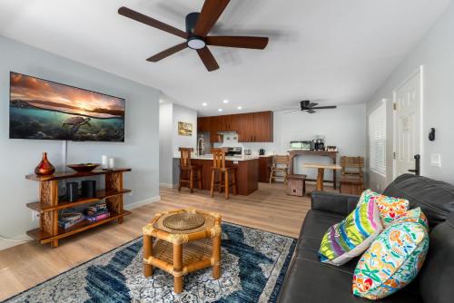 a living room with a couch and a ceiling fan at Big Island Fairway Terrace J-107 by Coldwell Banker Island Vacations in Waikoloa Village