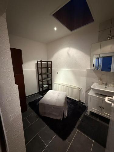 a bathroom with a bed and a sink at Apartment Bad Nauheim central in Bad Nauheim