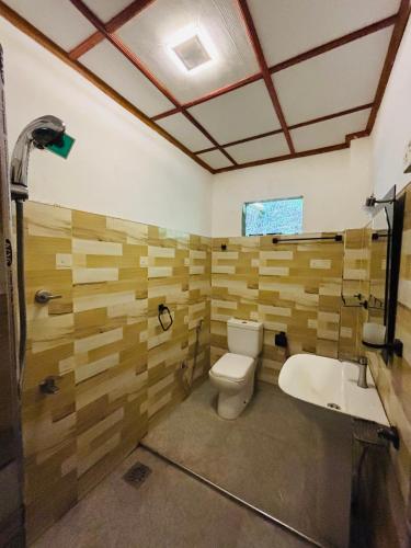 a bathroom with a toilet and a sink at Madiriya Forest Lodge Apartment in Badulla