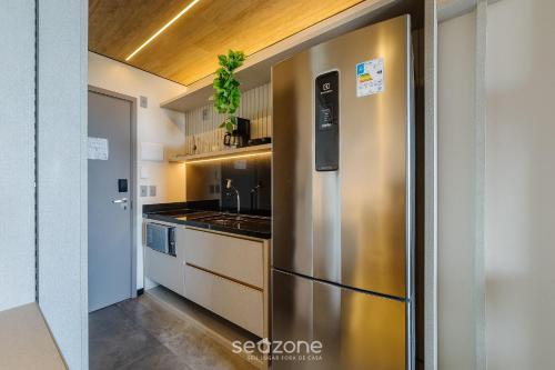 a kitchen with a stainless steel refrigerator at NWTs - Estúdios em Prédio com Vista Mar in Maceió