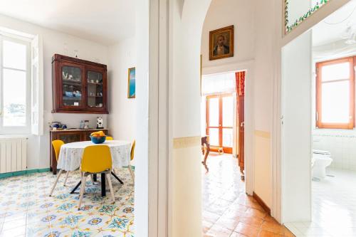 une salle à manger avec une table et des chaises jaunes dans l'établissement Al Fontanino rent house in amalfi coast, à Albori