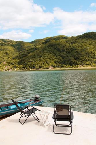 a pair of chairs sitting on the back of a boat at Drina River Retreat in Novo Selo