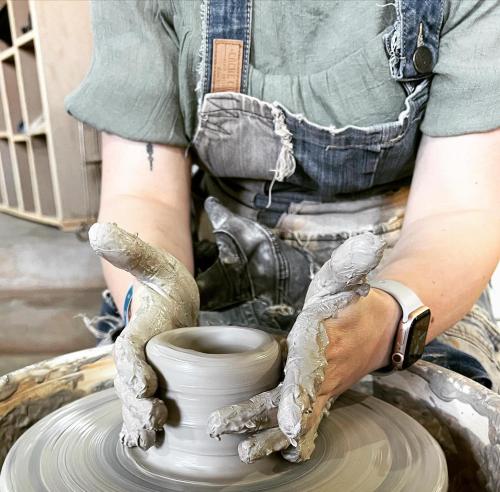 a person making a pot on a pottery wheel at Palais Nazha Fes - Luxury Lodging in Fès
