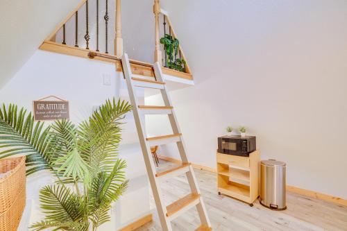 a wooden ladder next to a room with a microwave at Walk to Lake Taneycomo Cabin with Deck and Fire Pit! in Rockaway Beach