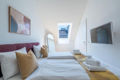 a bedroom with two beds and a tv on the wall at Vienna Stay Apartments Schönbrunn in Vienna