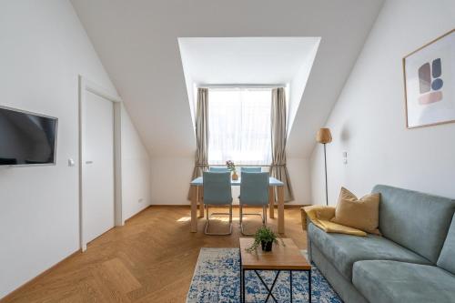 a living room with a couch and a table at Vienna Stay Apartments Schönbrunn in Vienna
