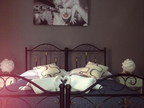 a bedroom with a bed with a poster of a woman at Alba Camere in Palermo