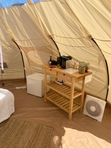 a room with a tent with a table in it at Luxe Glamping tent met sterrenhemel in Rijsenhout