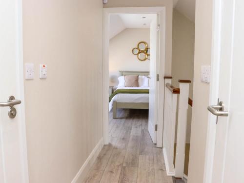 a hallway leading to a bedroom with a bed at Daly's Back House in Clogheen