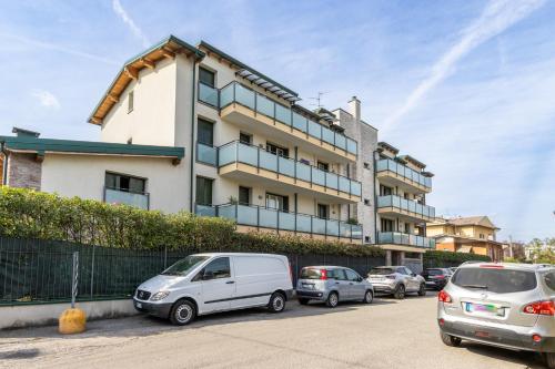 a building with cars parked in front of it at Spacious Apartment in Lissone in Desio