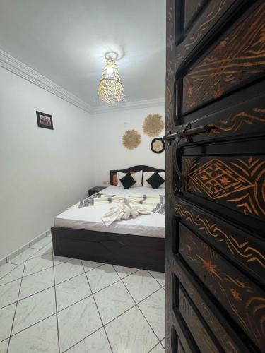 a bedroom with a bed in a room with a door at Riad Four Rooms & Pool in Marrakesh