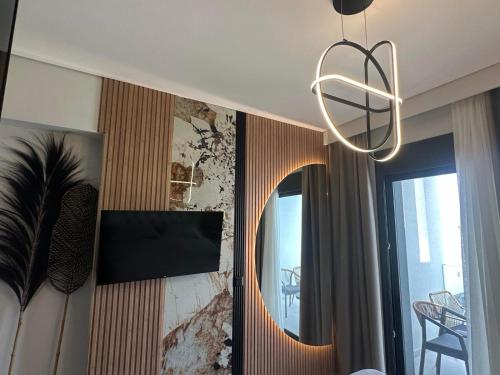 a living room with a mirror and a chandelier at Artion Suites Nikiti in Nikiti