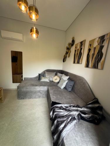 a room with two beds and a couch at Artion Suites Nikiti in Nikiti