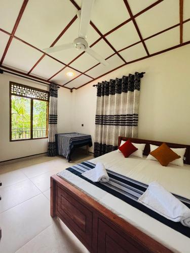 a bedroom with a large bed in a room at Madiriya Forest Lodge in Badulla