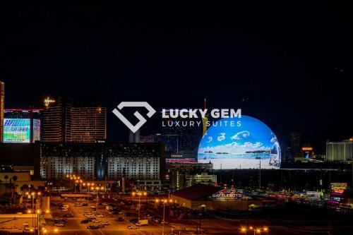a view of a city at night with a large sign at SPHERE VIEW - Signature MGM Resort Lucky Gem Penthouse & Luxury Suites 10817 in Las Vegas