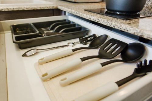 a group of utensils sitting on top of a stove at Accra Luxury Apartments at The Gallery in Accra