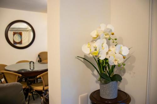 a vase of white flowers sitting on a table at Punta Esmeralda by Punta Leona in Jacó