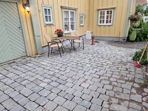 a patio with a table and chairs in front of a house at Madickenhuset in Söderköping