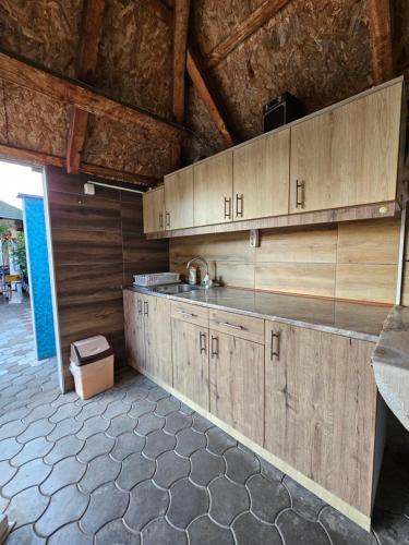 a kitchen with wooden cabinets in a room at Apartments Nikolić in Soko Banja