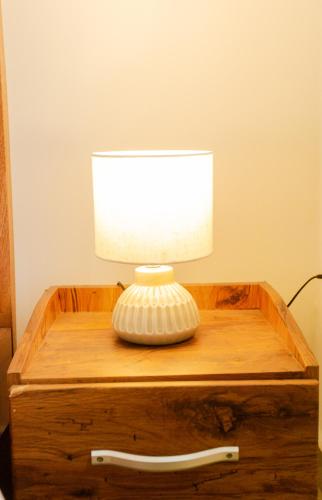a lamp sitting on top of a wooden table at Accra Luxury Apartments at The Gallery in Accra