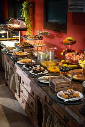 a buffet with many plates of food on a table at Hotel Costa Paradiso in Costa Paradiso