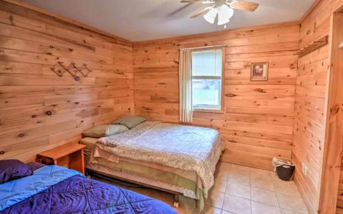 a bedroom with two beds in a log cabin at Charming Four-Bedroom Cabin Rental near Long Lake in Aroostook County, Maine in Lavertue