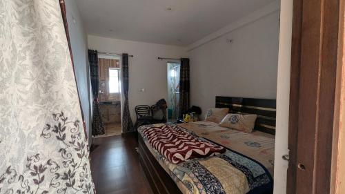 a bedroom with a large bed in a room at Quarali Homestay in Mukteswar