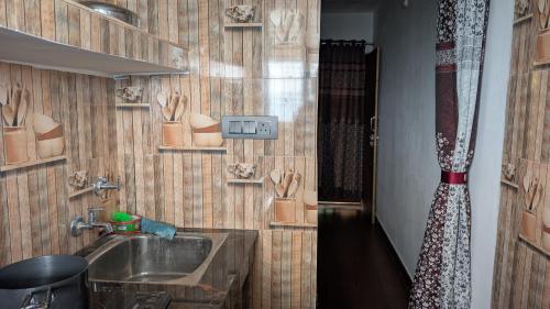 a bathroom with a sink and a shower at Quarali Homestay in Mukteswar