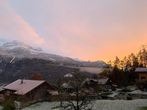 a view of a mountain with a lake and houses at Alpine feeling & lakeside in Kienholz