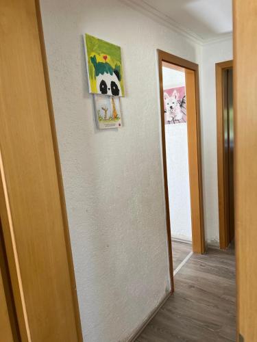 a hallway with a wall with a picture and a mirror at Frische Luft in Meschede