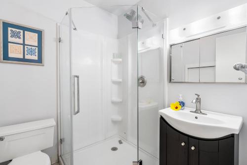 a white bathroom with a sink and a shower at Big Island Keauhou Punahele A301 by Coldwell Banker Island Vacations in Kailua-Kona