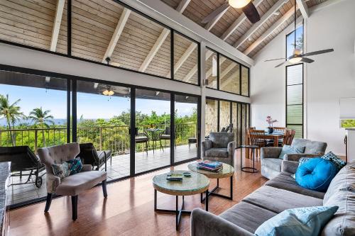a living room with a large glass wall at Big Island Keauhou Punahele A301 by Coldwell Banker Island Vacations in Kailua-Kona